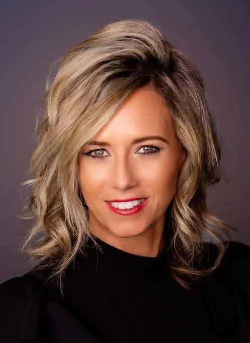 Studio headshot of CJ Ordonez against a dark backdrop